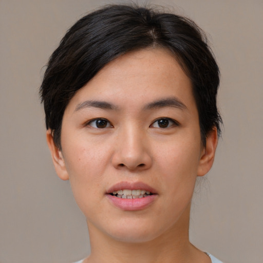 Joyful asian young-adult female with short  brown hair and brown eyes