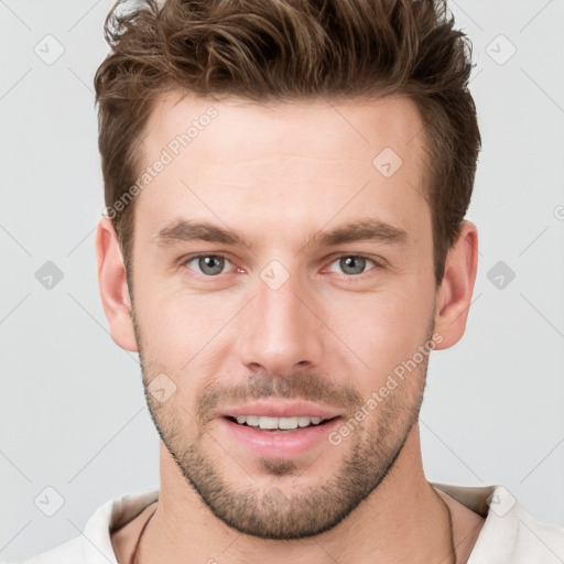 Joyful white young-adult male with short  brown hair and grey eyes