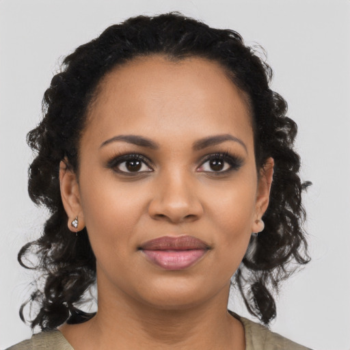 Joyful black young-adult female with medium  black hair and brown eyes
