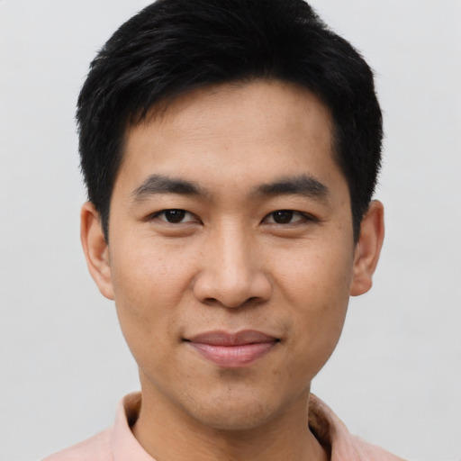 Joyful asian young-adult male with short  black hair and brown eyes