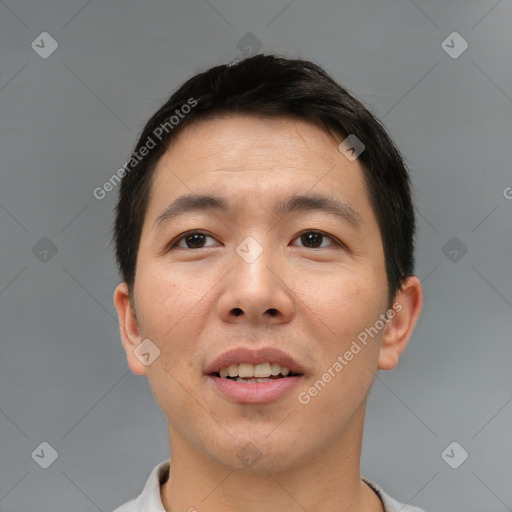 Joyful asian young-adult male with short  brown hair and brown eyes
