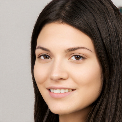 Joyful white young-adult female with long  black hair and brown eyes