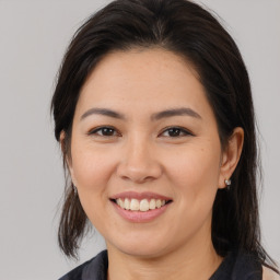 Joyful white young-adult female with medium  brown hair and brown eyes