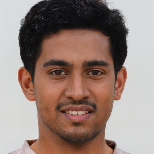 Joyful latino young-adult male with short  brown hair and brown eyes