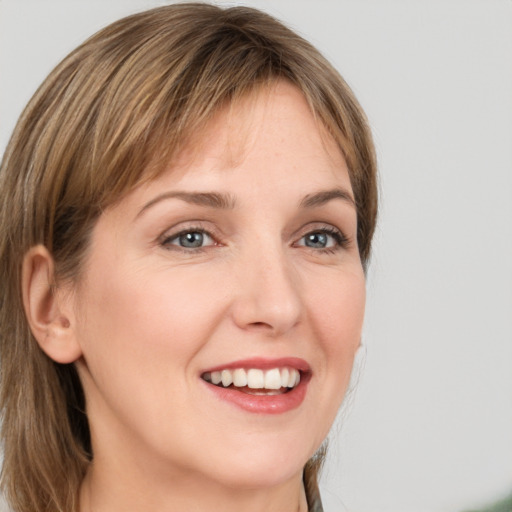 Joyful white young-adult female with medium  brown hair and green eyes