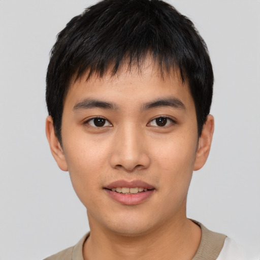 Joyful asian young-adult male with short  black hair and brown eyes