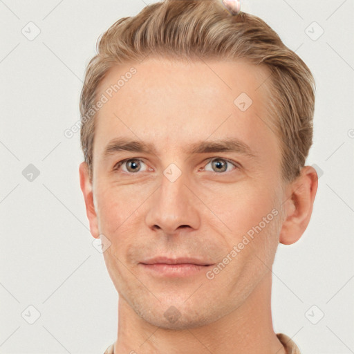 Joyful white young-adult male with short  brown hair and grey eyes