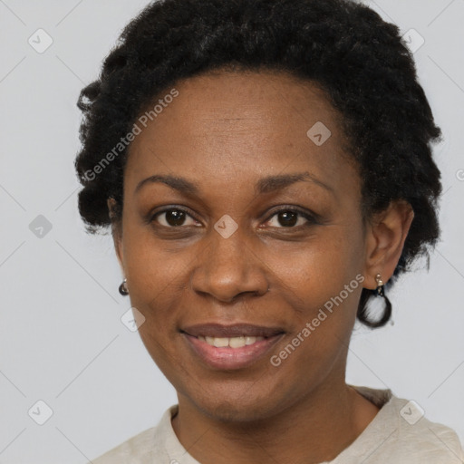 Joyful black adult female with short  black hair and brown eyes