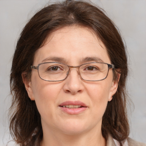 Joyful white adult female with medium  brown hair and grey eyes