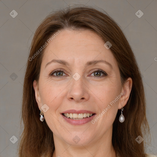 Joyful white adult female with long  brown hair and grey eyes