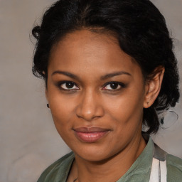 Joyful black young-adult female with medium  brown hair and brown eyes