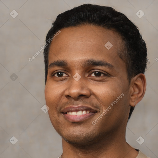 Joyful black young-adult male with short  black hair and brown eyes