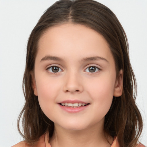 Joyful white child female with long  brown hair and brown eyes