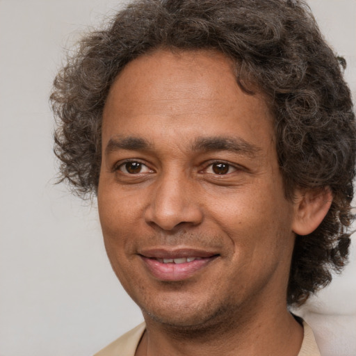 Joyful latino adult male with short  brown hair and brown eyes