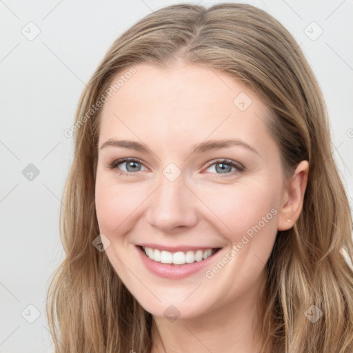 Joyful white young-adult female with long  brown hair and grey eyes