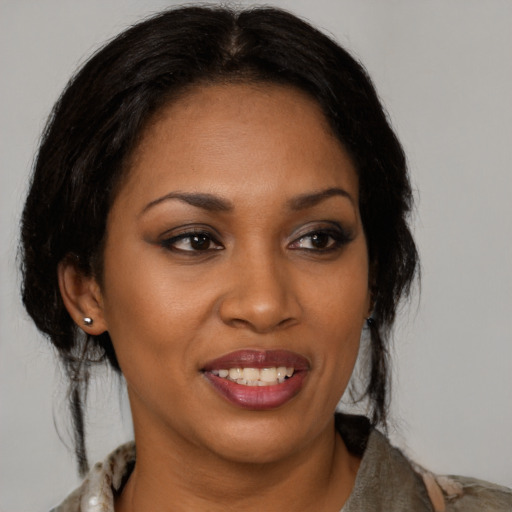 Joyful black young-adult female with medium  brown hair and brown eyes
