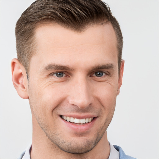 Joyful white young-adult male with short  brown hair and grey eyes