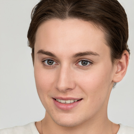 Joyful white young-adult female with short  brown hair and brown eyes