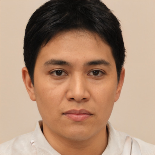 Joyful asian young-adult male with short  brown hair and brown eyes