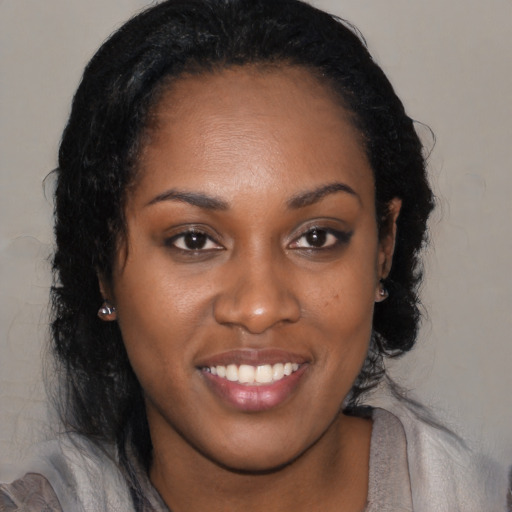 Joyful black young-adult female with medium  brown hair and brown eyes