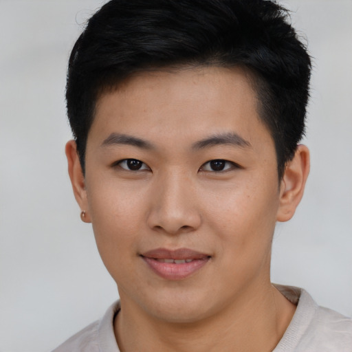 Joyful asian young-adult female with short  black hair and brown eyes