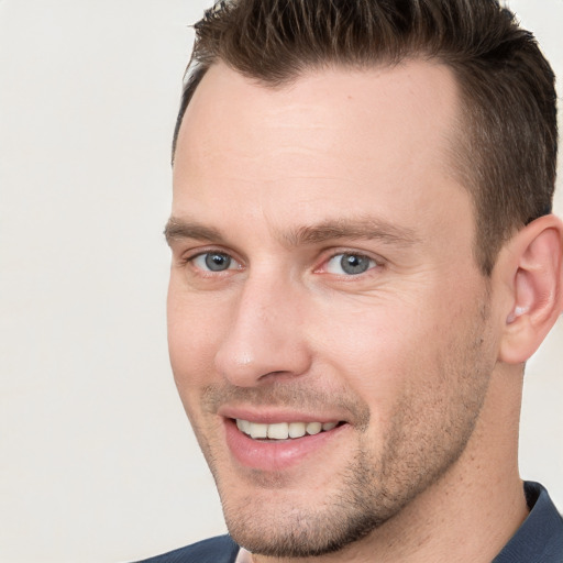 Joyful white young-adult male with short  brown hair and brown eyes