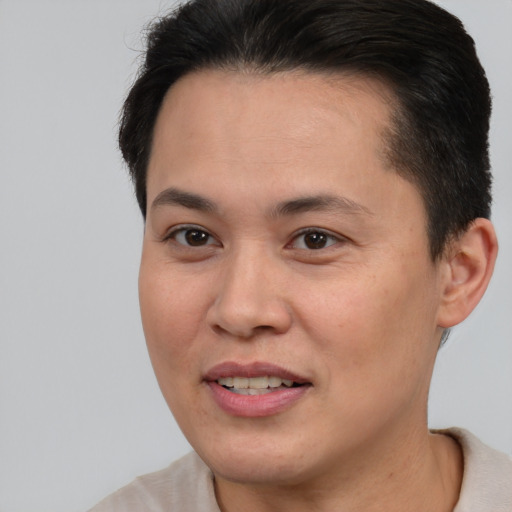Joyful asian young-adult female with short  brown hair and brown eyes