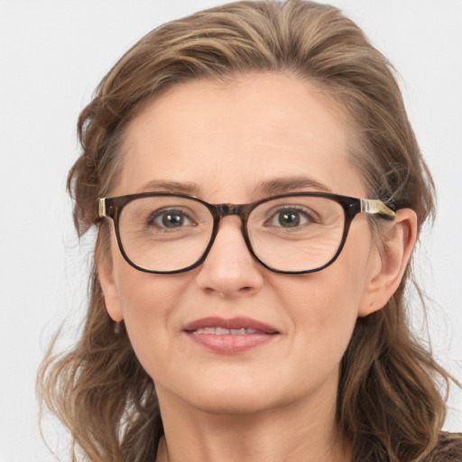 Joyful white adult female with medium  brown hair and blue eyes