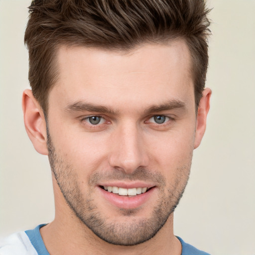 Joyful white young-adult male with short  brown hair and grey eyes