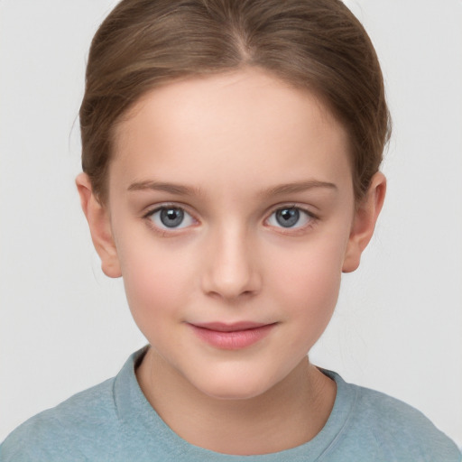 Joyful white child female with short  brown hair and grey eyes