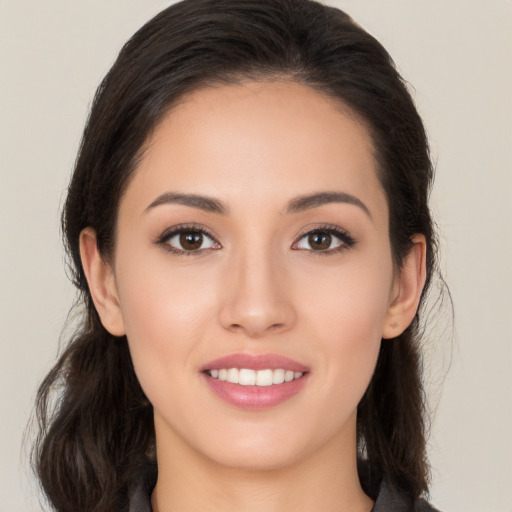 Joyful white young-adult female with long  brown hair and brown eyes