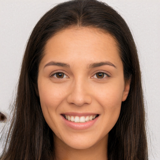 Joyful white young-adult female with long  brown hair and brown eyes