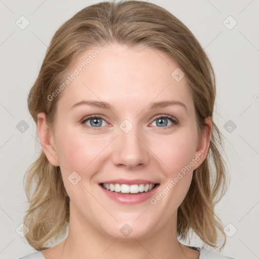 Joyful white young-adult female with medium  brown hair and blue eyes