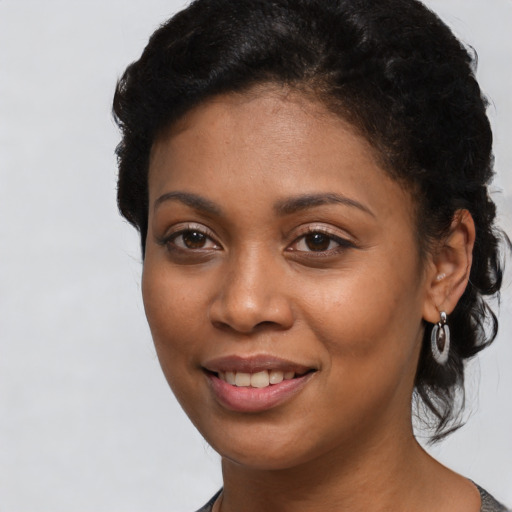 Joyful latino young-adult female with short  black hair and brown eyes