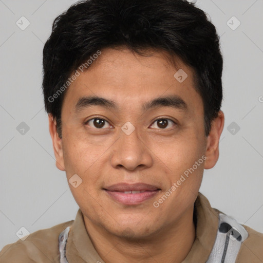 Joyful asian young-adult male with short  brown hair and brown eyes