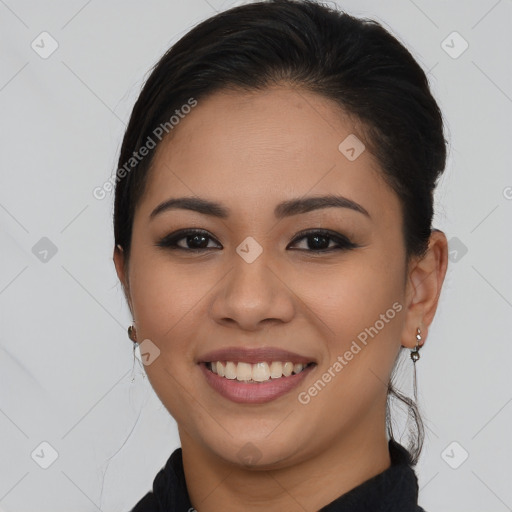 Joyful latino young-adult female with long  brown hair and brown eyes