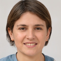 Joyful white young-adult female with medium  brown hair and grey eyes