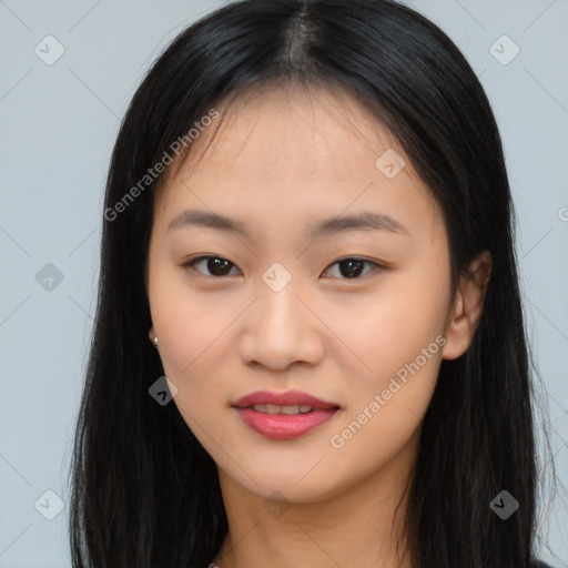 Joyful asian young-adult female with long  black hair and brown eyes