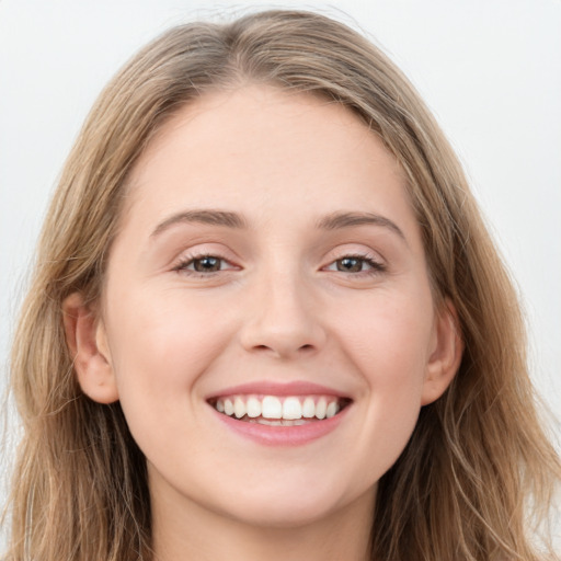 Joyful white young-adult female with long  brown hair and grey eyes