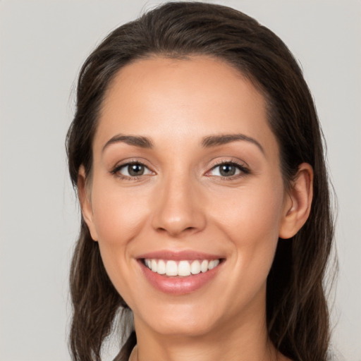 Joyful white young-adult female with medium  brown hair and brown eyes