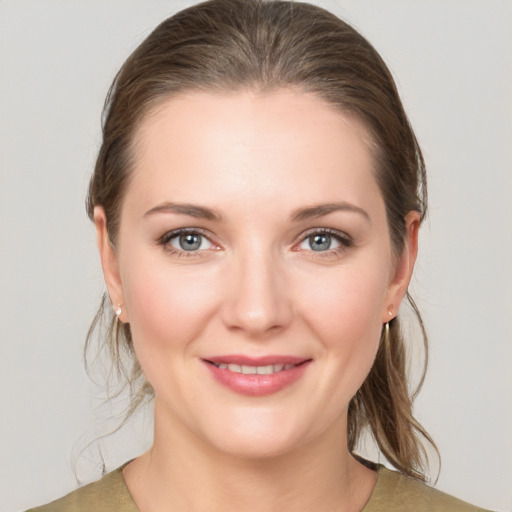 Joyful white young-adult female with medium  brown hair and grey eyes