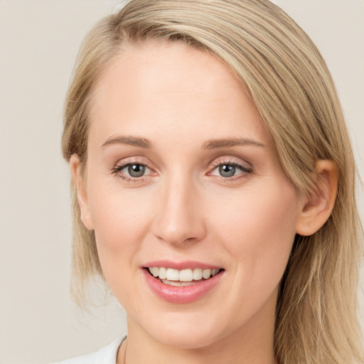 Joyful white young-adult female with long  brown hair and blue eyes