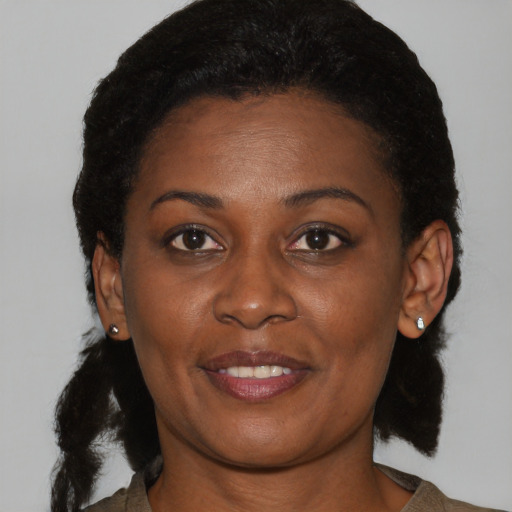 Joyful black young-adult female with medium  brown hair and brown eyes