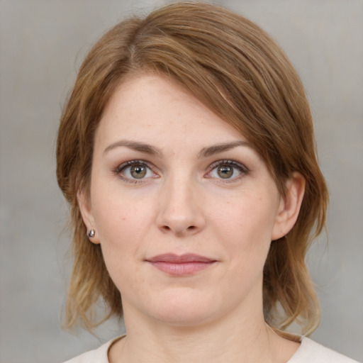 Joyful white young-adult female with medium  brown hair and blue eyes