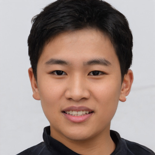 Joyful asian young-adult male with short  black hair and brown eyes