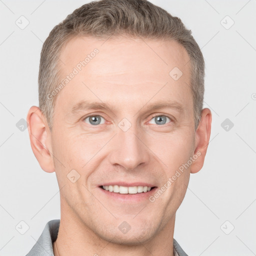 Joyful white adult male with short  brown hair and grey eyes