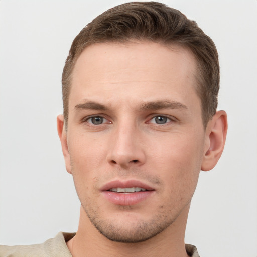 Joyful white young-adult male with short  brown hair and grey eyes