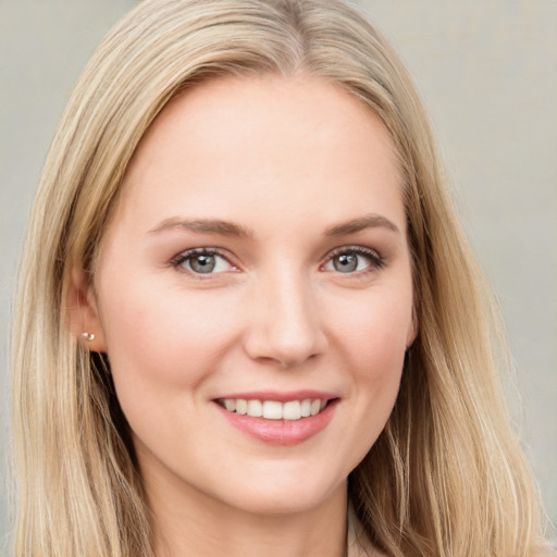 Joyful white young-adult female with long  brown hair and blue eyes