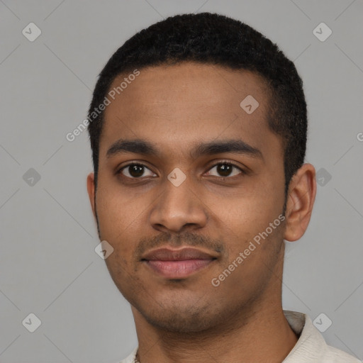 Joyful black young-adult male with short  black hair and brown eyes