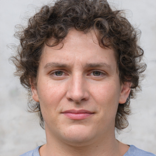 Joyful white young-adult male with medium  brown hair and brown eyes